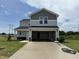 Two-story home with attached two-car garage, siding, and large concrete driveway at 37 Chloe Ct, Selma, NC 27576