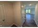 Inviting hallway featuring wood-style flooring, leading to a brightly lit living space at 37 Chloe Ct, Selma, NC 27576