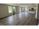 Spacious living room featuring light gray walls, luxury vinyl plank flooring, and natural light at 37 Chloe Ct, Selma, NC 27576