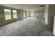 Spacious unfinished living room with multiple windows and a walk-out door for customization at 37 Chloe Ct, Selma, NC 27576