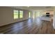 Spacious living area with wood flooring, natural light, and seamless flow into the kitchen at 37 Chloe Ct, Selma, NC 27576