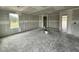 Bright, unfinished living room with large windows, ample space, and ready for personalization at 37 Chloe Ct, Selma, NC 27576