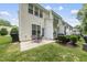 A charming backyard featuring a cozy patio and green space that complements the home's neutral siding at 4413 Sugarbend Way, Raleigh, NC 27606
