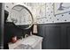 Stylish powder room with modern fixtures, unique wall decor, and a sleek vanity at 4413 Sugarbend Way, Raleigh, NC 27606