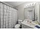 Bathroom with white fixtures, and a combination shower and bathtub at 4413 Sugarbend Way, Raleigh, NC 27606