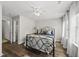 Comfortable bedroom featuring wood flooring, ceiling fan, and a view to the bathroom at 4413 Sugarbend Way, Raleigh, NC 27606