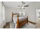 Bedroom with wood bed frame, wood floors, ceiling fan, and neutral color palette at 4413 Sugarbend Way, Raleigh, NC 27606