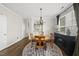 Elegant dining area featuring a round wooden table, stylish chandelier, and contemporary decor at 4413 Sugarbend Way, Raleigh, NC 27606