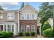 Charming townhome featuring a brick facade and a well-maintained front yard with lush greenery at 4413 Sugarbend Way, Raleigh, NC 27606