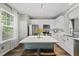 Bright kitchen features white cabinets, stainless steel appliances, and an island with seating at 4413 Sugarbend Way, Raleigh, NC 27606