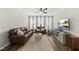 Comfortable living room with a leather sofa set, modern entertainment center, and abundant natural light at 4413 Sugarbend Way, Raleigh, NC 27606