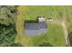 Aerial view of a quaint home with a backyard deck, surrounded by lush greenery at 445 Lee County Line Rd, Broadway, NC 27505