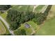 Aerial view of a house with a large yard surrounded by trees and farmland at 445 Lee County Line Rd, Broadway, NC 27505