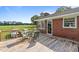 Back deck of a charming brick home overlooking a lush green field at 445 Lee County Line Rd, Broadway, NC 27505