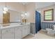 Classic bathroom featuring a vanity with ample storage and a shower-tub combination at 445 Lee County Line Rd, Broadway, NC 27505