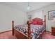 Bedroom featuring a wooden four poster bed with bright pillows and a geometric patterned quilt at 445 Lee County Line Rd, Broadway, NC 27505