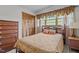 Cozy bedroom with natural light, featuring a bed with decorative pillows and a wooden dresser at 445 Lee County Line Rd, Broadway, NC 27505