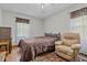 Bedroom featuring a cozy recliner, a full sized bed, and dark wood flooring at 445 Lee County Line Rd, Broadway, NC 27505