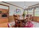 Charming dining room with wood table, chairs, hardwood floors, and a view to the brick fireplace at 445 Lee County Line Rd, Broadway, NC 27505