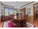 Traditional dining room with a wood table, china cabinet, and bright window at 445 Lee County Line Rd, Broadway, NC 27505