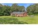 Charming brick home with a well-maintained lawn, mature trees, and a classic architectural style at 445 Lee County Line Rd, Broadway, NC 27505