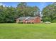 Charming brick home with a well-maintained lawn and mature trees at 445 Lee County Line Rd, Broadway, NC 27505