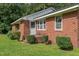 Exterior view of a brick house, highlighting its well-maintained landscaping and classic curb appeal at 445 Lee County Line Rd, Broadway, NC 27505