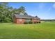 Charming single-story brick home with a well-maintained lawn and mature trees at 445 Lee County Line Rd, Broadway, NC 27505