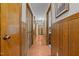 Long hallway featuring wood paneling, storage closets, and natural light at 445 Lee County Line Rd, Broadway, NC 27505