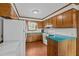 Retro kitchen design featuring wood cabinets, blue countertops, and classic appliances at 445 Lee County Line Rd, Broadway, NC 27505