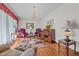 Elegant living room featuring hardwood floors, a piano, and comfortable seating at 445 Lee County Line Rd, Broadway, NC 27505