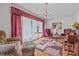 Cozy living room with decorative curtains, comfortable seating, and ample natural light at 445 Lee County Line Rd, Broadway, NC 27505