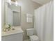 Bright bathroom with white vanity, decorative mirror, and shower with tub combination at 4619 Regency Dr, Durham, NC 27713