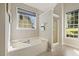Relaxing bathroom with a soaking tub, separate glass shower, and a window view at 4619 Regency Dr, Durham, NC 27713