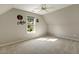 Sloped ceiling bedroom features a window providing natural light and carpeted floors at 4619 Regency Dr, Durham, NC 27713