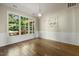 Formal dining area with wainscoting, a chandelier, and large windows offering scenic views at 4619 Regency Dr, Durham, NC 27713