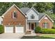 Beautiful two-story brick home with an attached two-car garage and well-manicured landscaping at 4619 Regency Dr, Durham, NC 27713