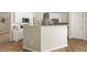 Bright kitchen features white cabinetry, stainless steel appliances, and a breakfast bar island at 4619 Regency Dr, Durham, NC 27713