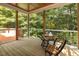 Relaxing screened porch with an outdoor table and views of the surrounding greenery at 4619 Regency Dr, Durham, NC 27713