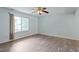 Bedroom featuring modern flooring, a ceiling fan, and a bright window with natural light at 4709 Tyne Dr, Durham, NC 27703