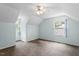 Bright, sunlit bedroom boasts neutral tones, plush carpeting, and modern ceiling fan at 4709 Tyne Dr, Durham, NC 27703