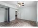 This bedroom features hardwood floors, ceiling fan, closet, and an entrance into the laundry room at 4709 Tyne Dr, Durham, NC 27703