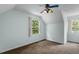 This bedroom features carpet floors, windows, and a colorful ceiling fan at 4709 Tyne Dr, Durham, NC 27703