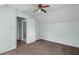 This bedroom features carpet floors, a ceiling fan, and a white door at 4709 Tyne Dr, Durham, NC 27703