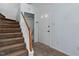 The home's entryway features carpeted stairs, wood-look vinyl flooring, and white painted walls at 4709 Tyne Dr, Durham, NC 27703