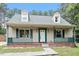 Charming home featuring a cozy front porch and dormer windows at 4709 Tyne Dr, Durham, NC 27703