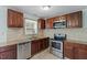 Bright kitchen featuring stainless steel appliances, granite countertops, and ample storage at 4709 Tyne Dr, Durham, NC 27703