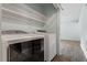 This laundry room features washer, dryer, white shelves, and tile flooring at 4709 Tyne Dr, Durham, NC 27703