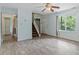 Open living space with wood-look flooring, stairs to the upper level, and a large window at 4709 Tyne Dr, Durham, NC 27703
