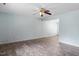Spacious living room with light blue walls, ceiling fan and modern wood-look flooring at 4709 Tyne Dr, Durham, NC 27703